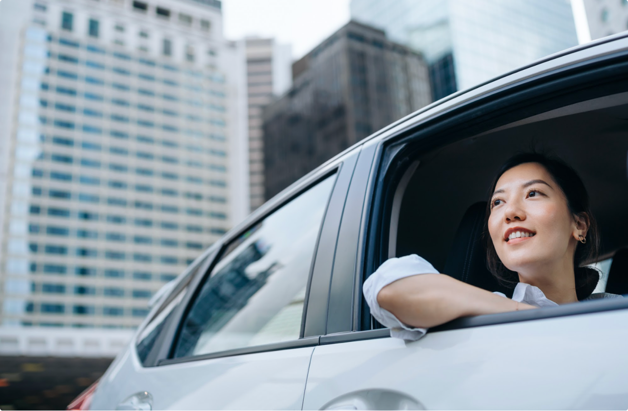 Woman looking out window of car